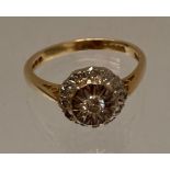 An 18ct gold diamond cluster ring, size L, hallmarked,