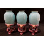 A set of three turquoise Minton vases set in purple stands each 16cm high - one bad chip to top rim