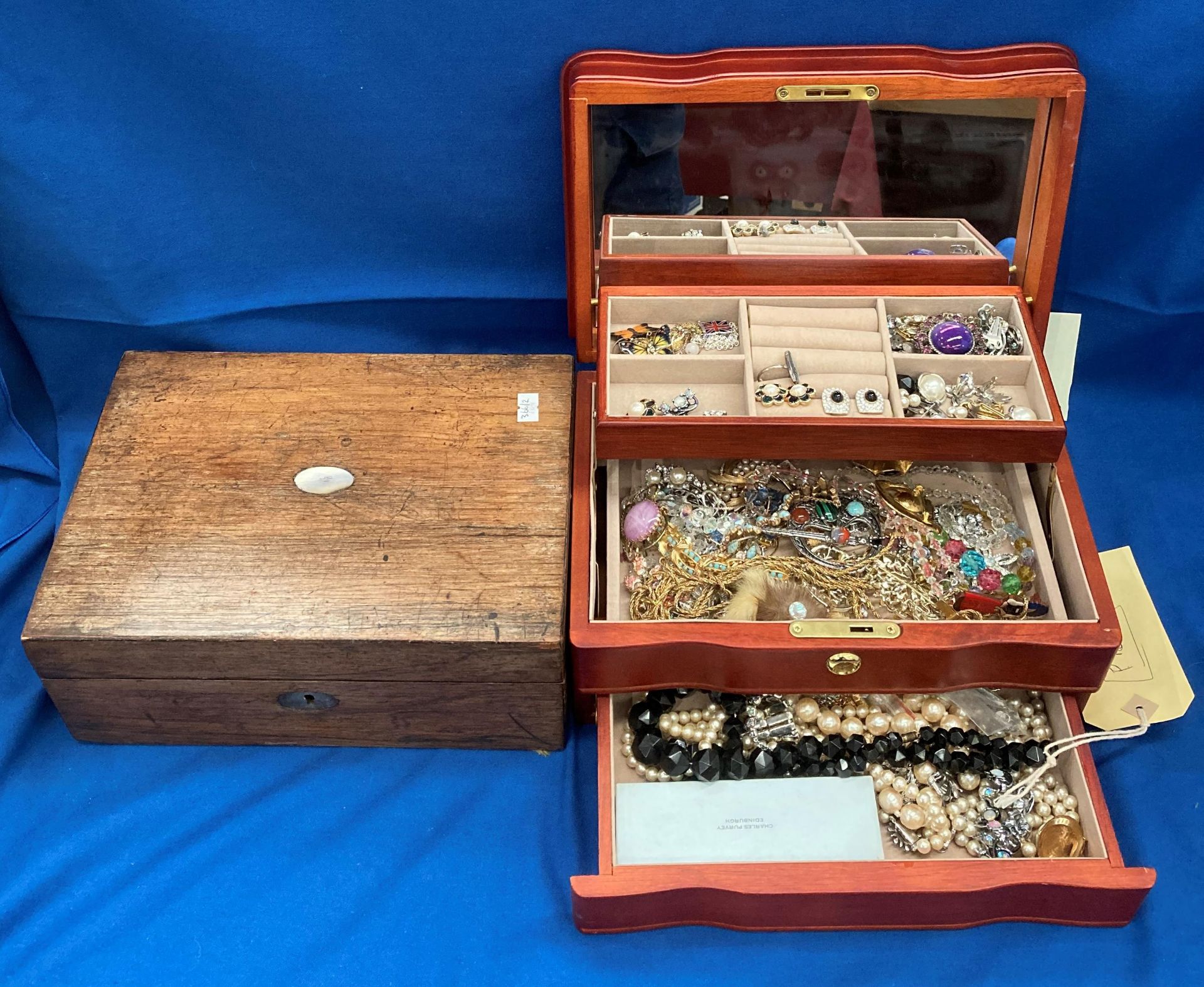 A wood jewellery box containing black bead necklace, diamante, simulated pearl and other necklaces,