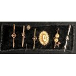 Seven items - a 15ct gold tie pin and bar brooch, two 9ct gold bar brooches,