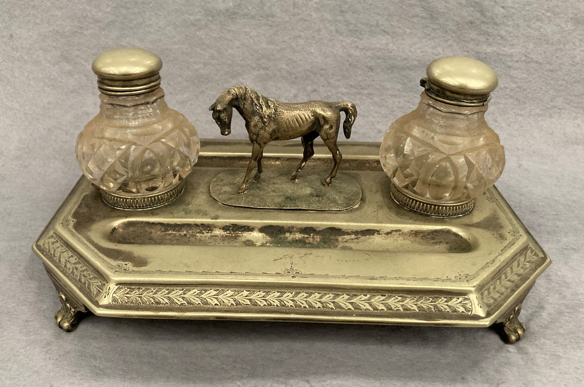 A plated Equine ink stand and pen tray with two glass ink bottles 28cm x 20cm
