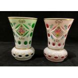 Two white patterned vases, one with green and one with pink glass liners each 14cm high.