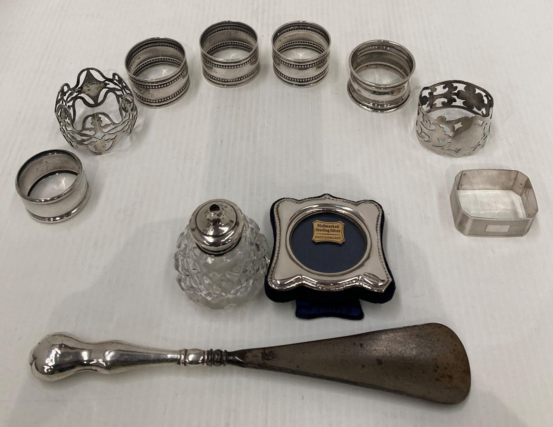 Eleven silver items including seven assorted silver napkin rings and one other,