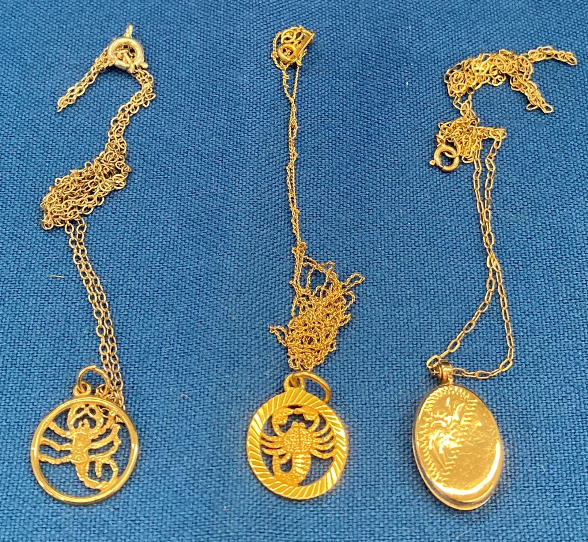 Two 9ct gold chains and pendants, a 9ct gold scorpion pendant and a silver chain - gold weight 5.