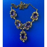 A 9ct yellow gold necklace set with five oval amethysts - total weight 20.4 grams.