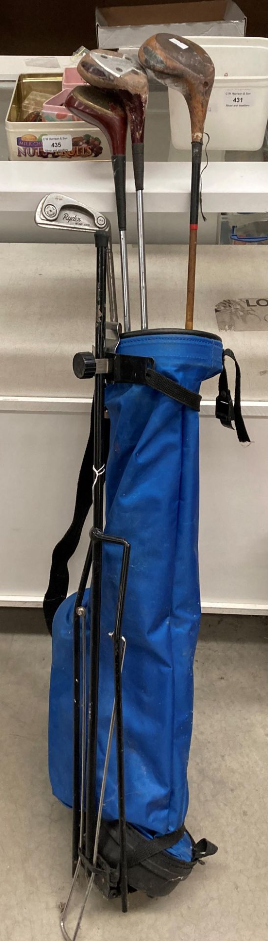 A blue canvas golf bag containing three various woods - Slazenger Ben Hogan,