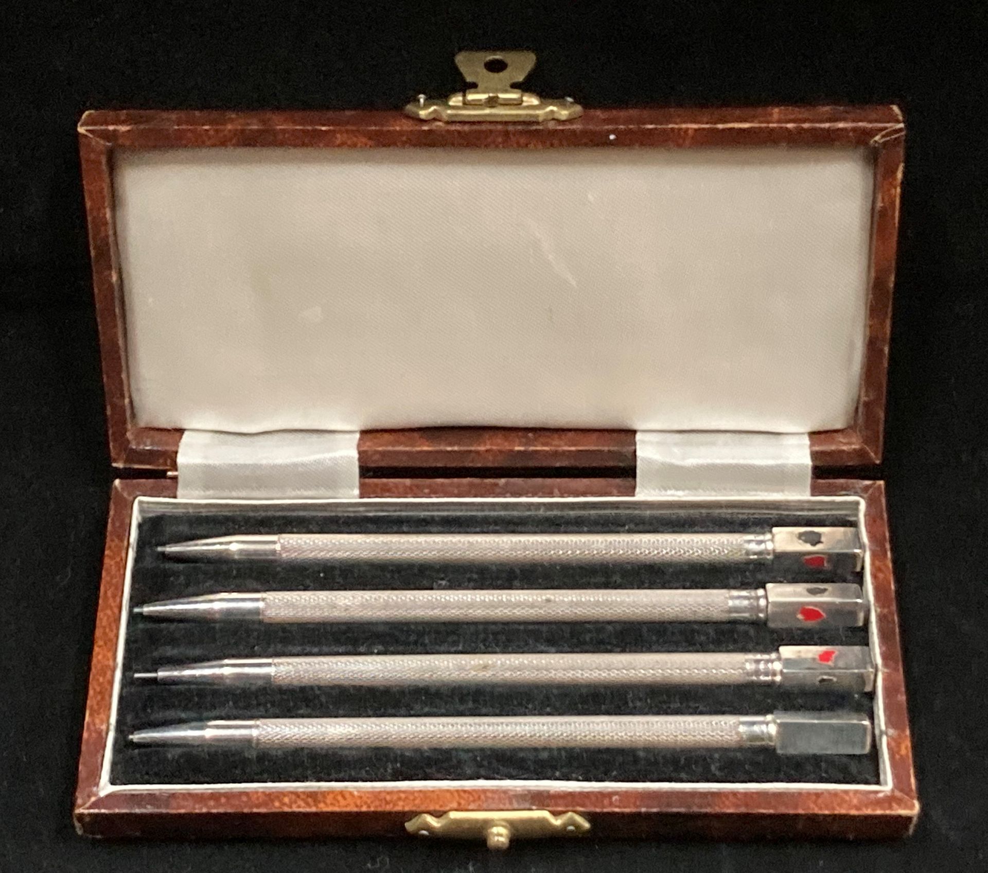 A set of four silver Cribbage propelling pencils in a fitted case.