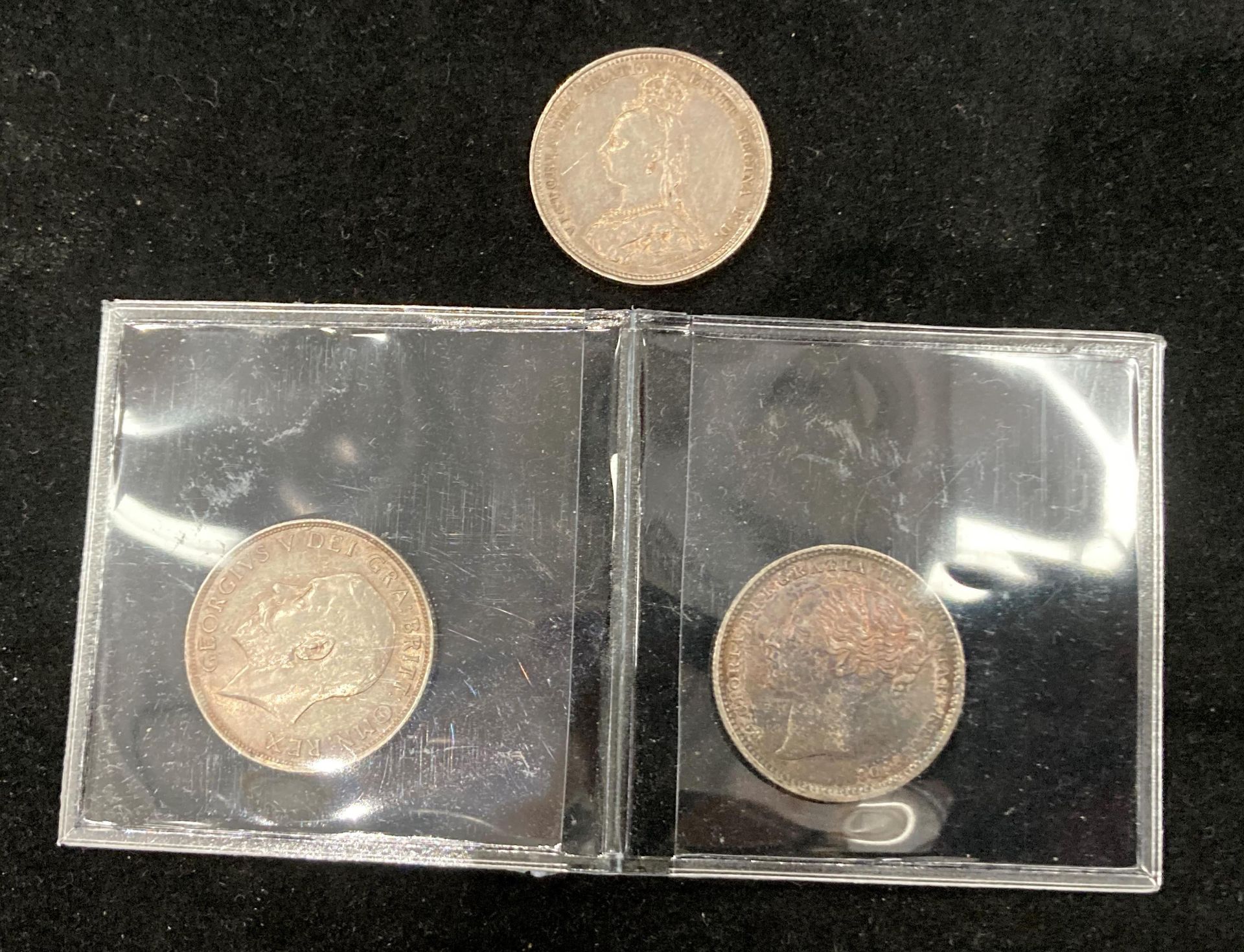 Three high grade silver shillings - 1883, 1888 and 1911.