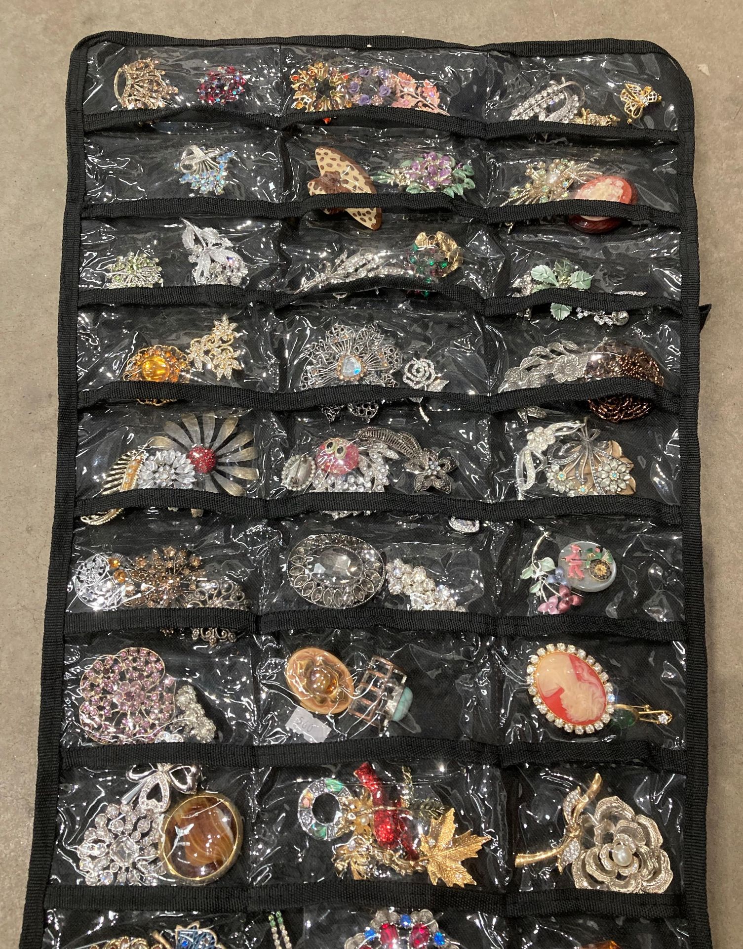 Roll up bag holder with large quantity of assorted brooches. - Image 2 of 3