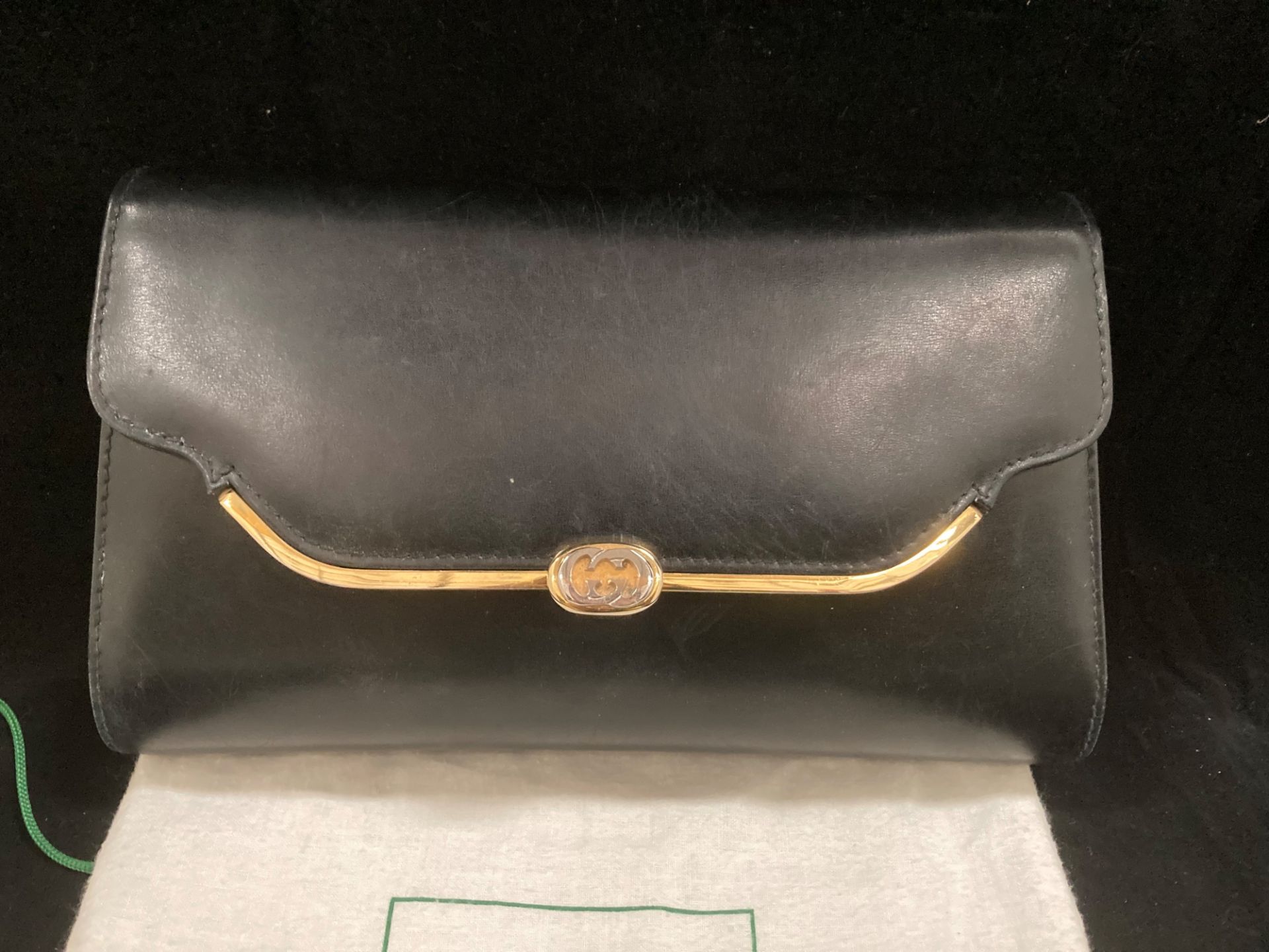 A Gucci black leather clutch bag including a long strap and protective bag. - Image 2 of 3