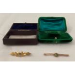 Two 9ct gold brooches in cases, one with light green stone and one with blue stone - total weight 4.