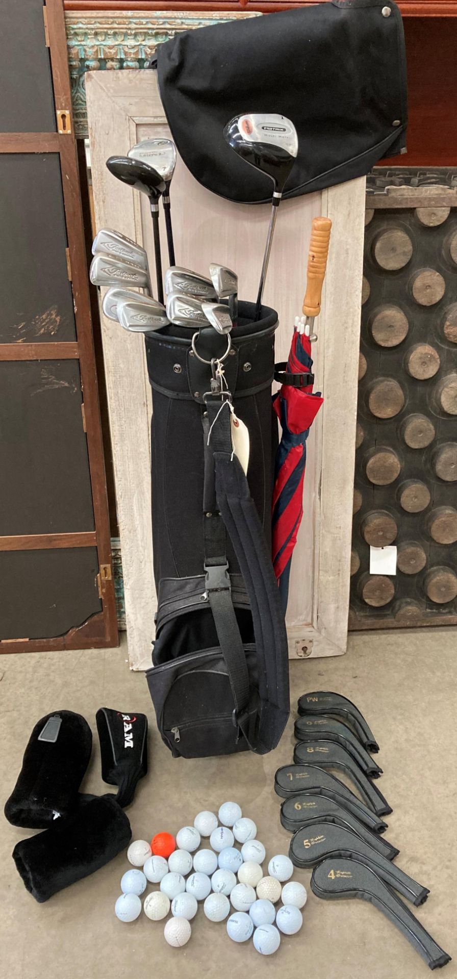 A black polyester golf bag containing a Wilson Matrix 10.