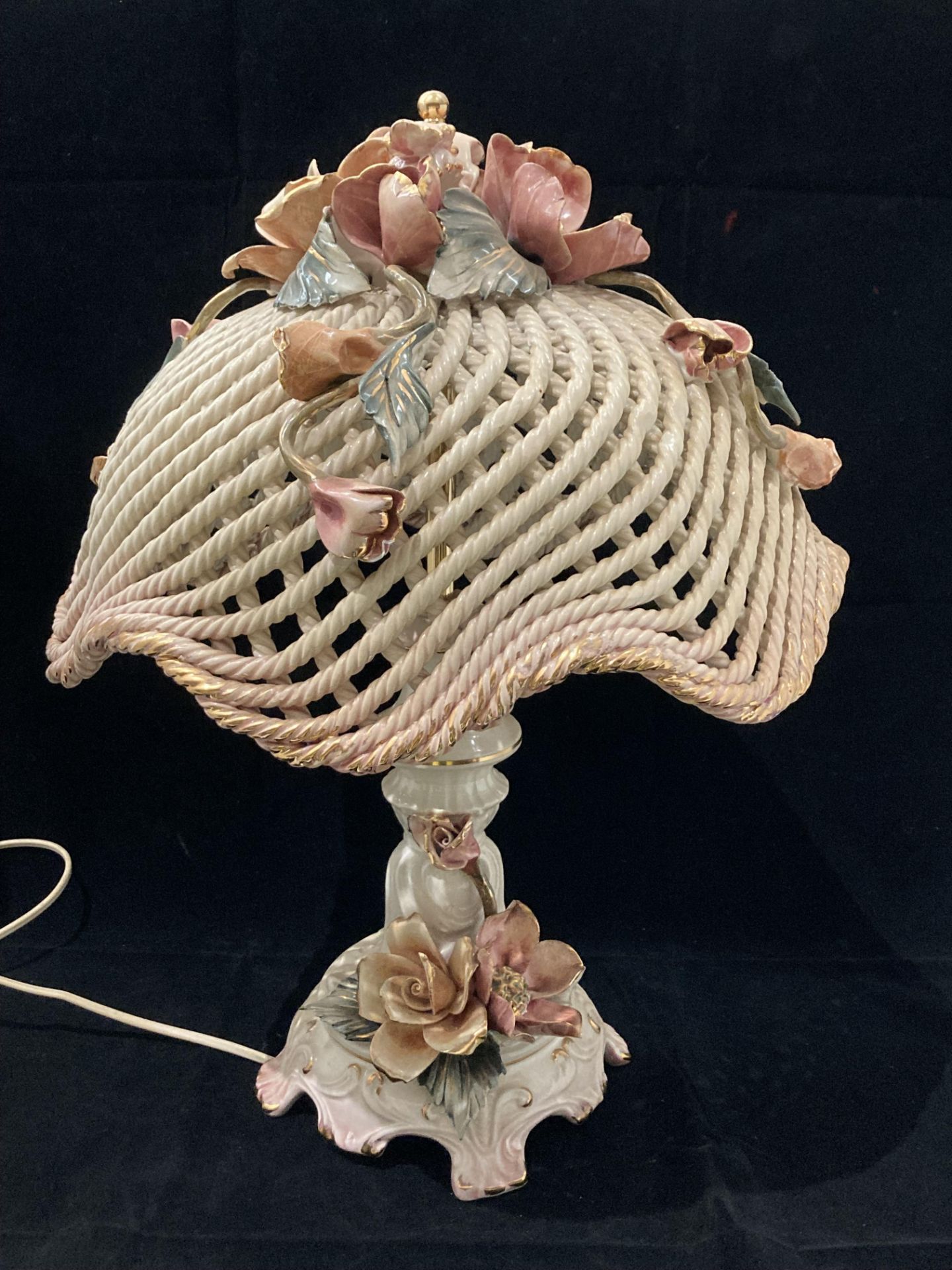 A Capo di Monte floral patterned table lamp with basket weave shade - one flower to shade is