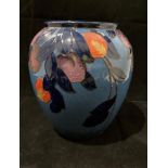 A 'B & L Limited' Burleigh Ware Charlotte Rhead blue glazed fruit patterned vase 21.