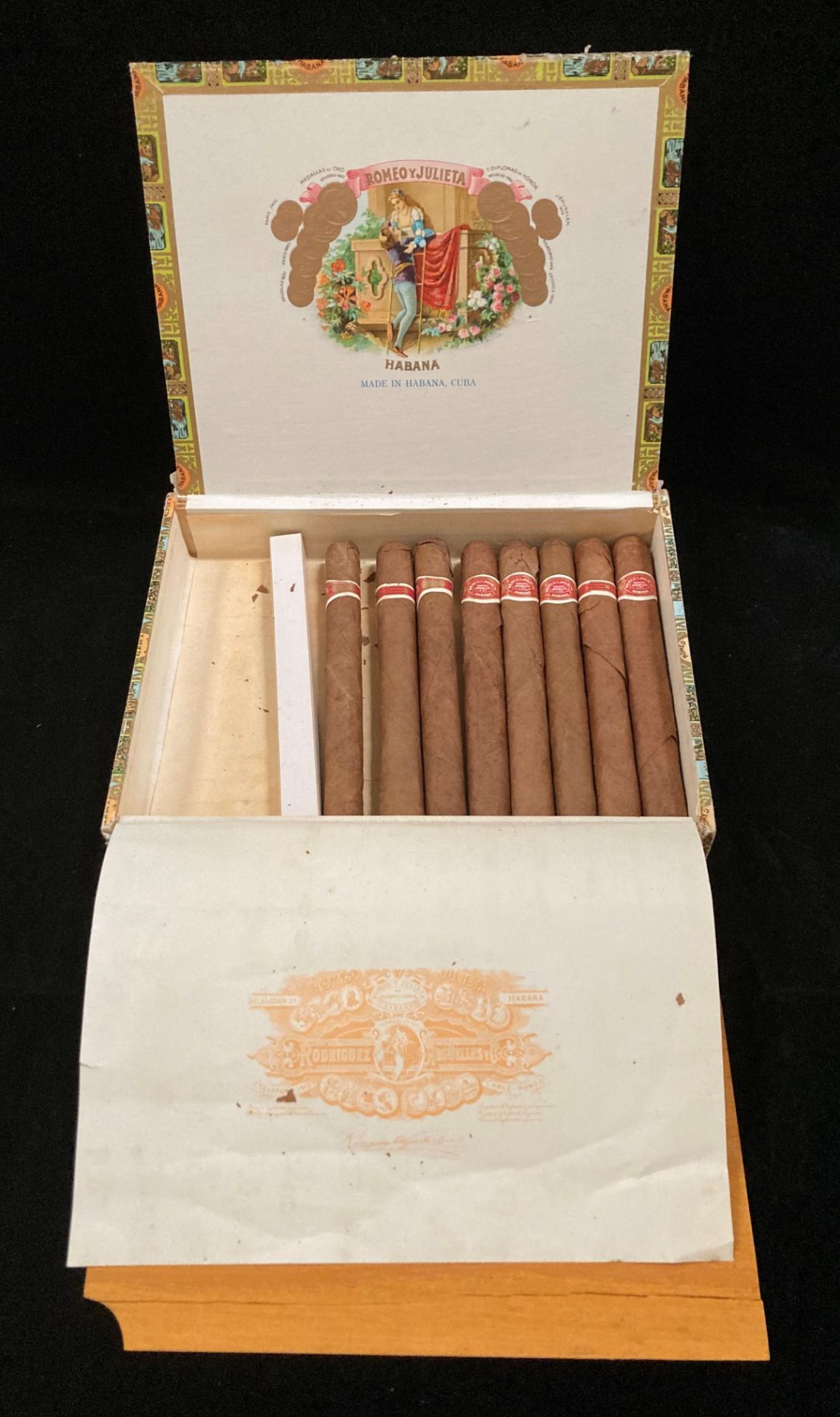 A cigar box containing eight Romeo and Julieta Habana cigars