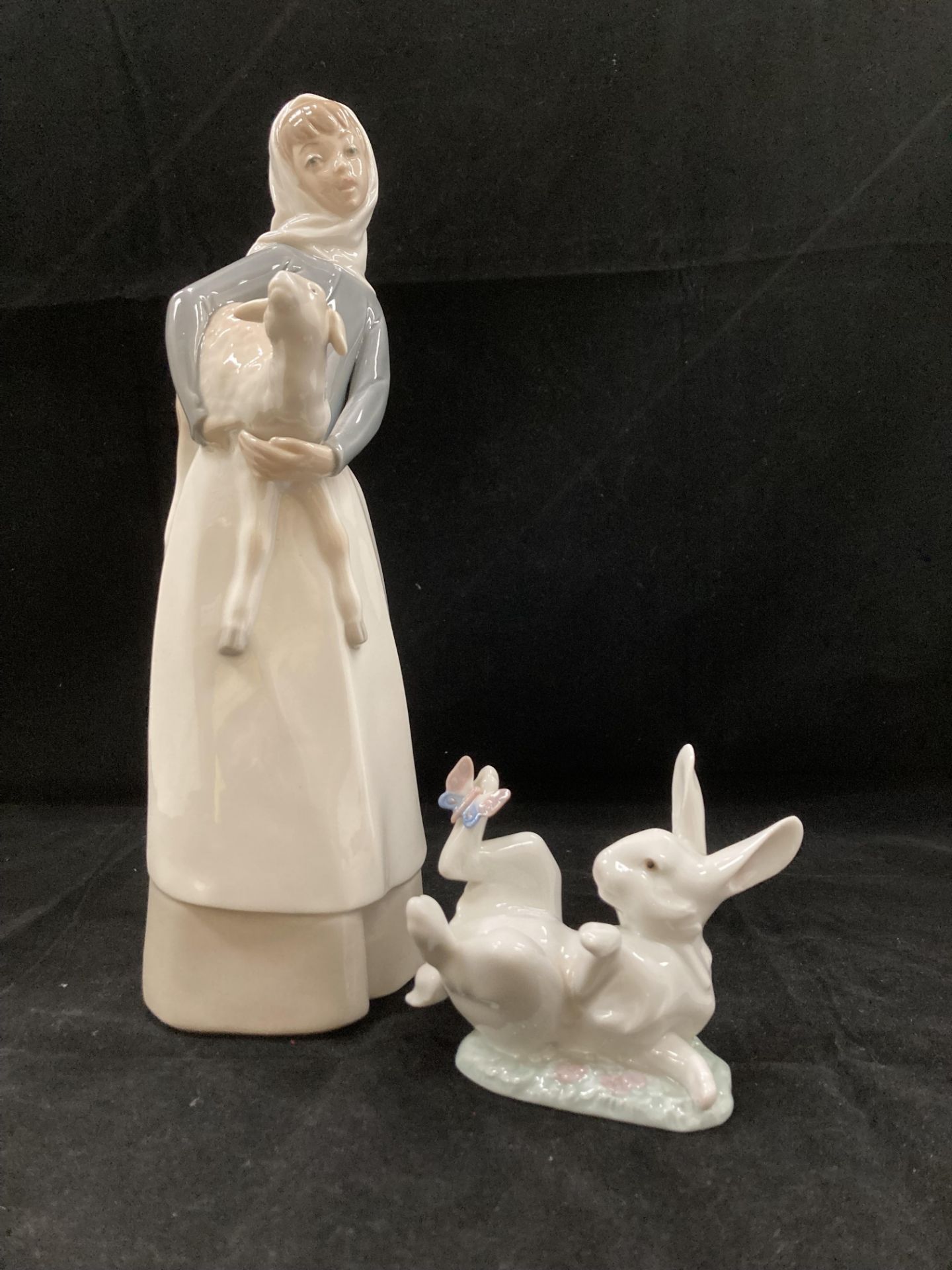 A Lladro figurine of a young girl holding a lamb and a Lladro rabbit with a butterfly No 5888 (2)