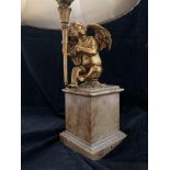 A gilt metal table lamp on brown marble base,