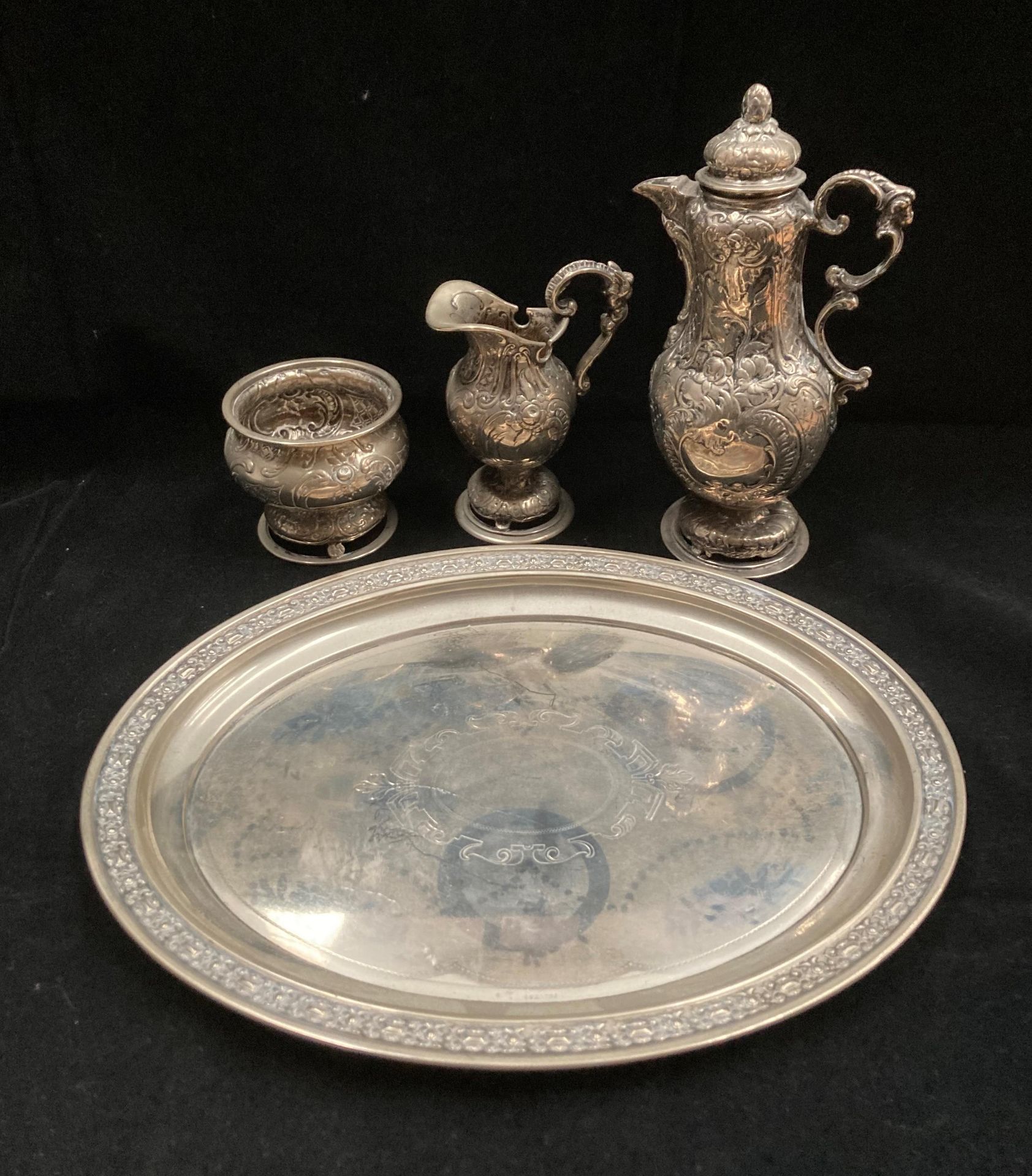 An embossed continental silver three piece coffee set comprising coffee jug 19cm high,