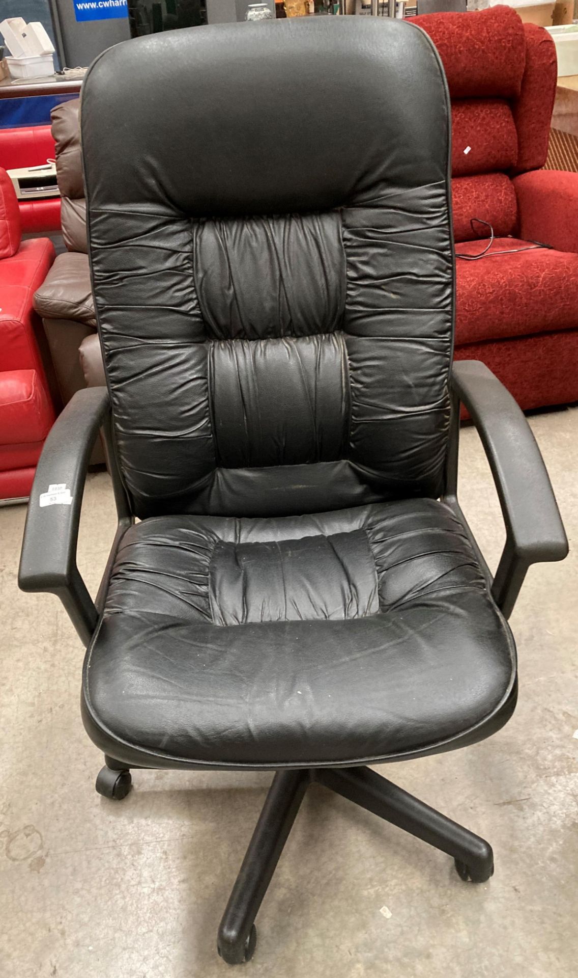 A black leather effect high back swivel armchair