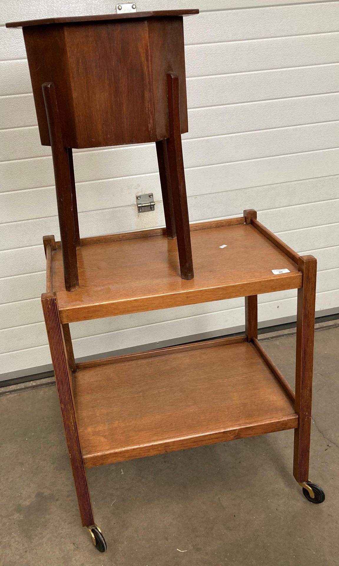 A wooden two tier mobile tea trolley and hexagonal wooden sewing box on legs