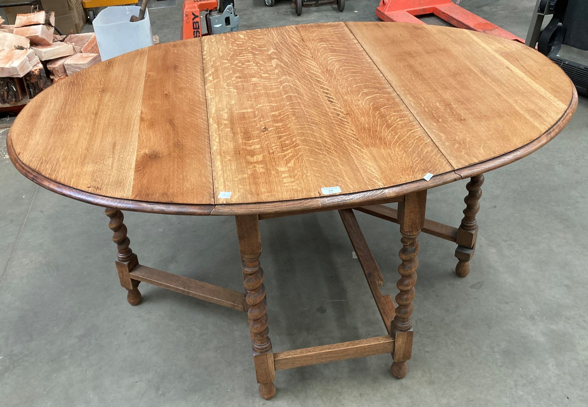 An oak drop leaf oval dining table with barley twist legs 150cm x 106cm