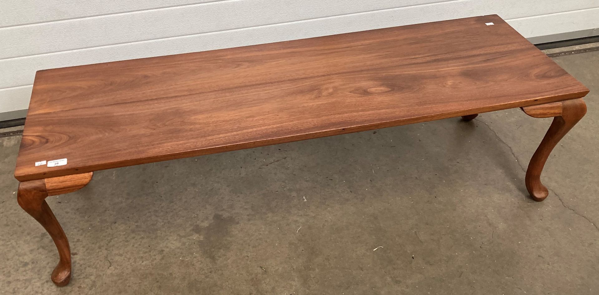 A rectangular wooden coffee table 128cm x 43cm