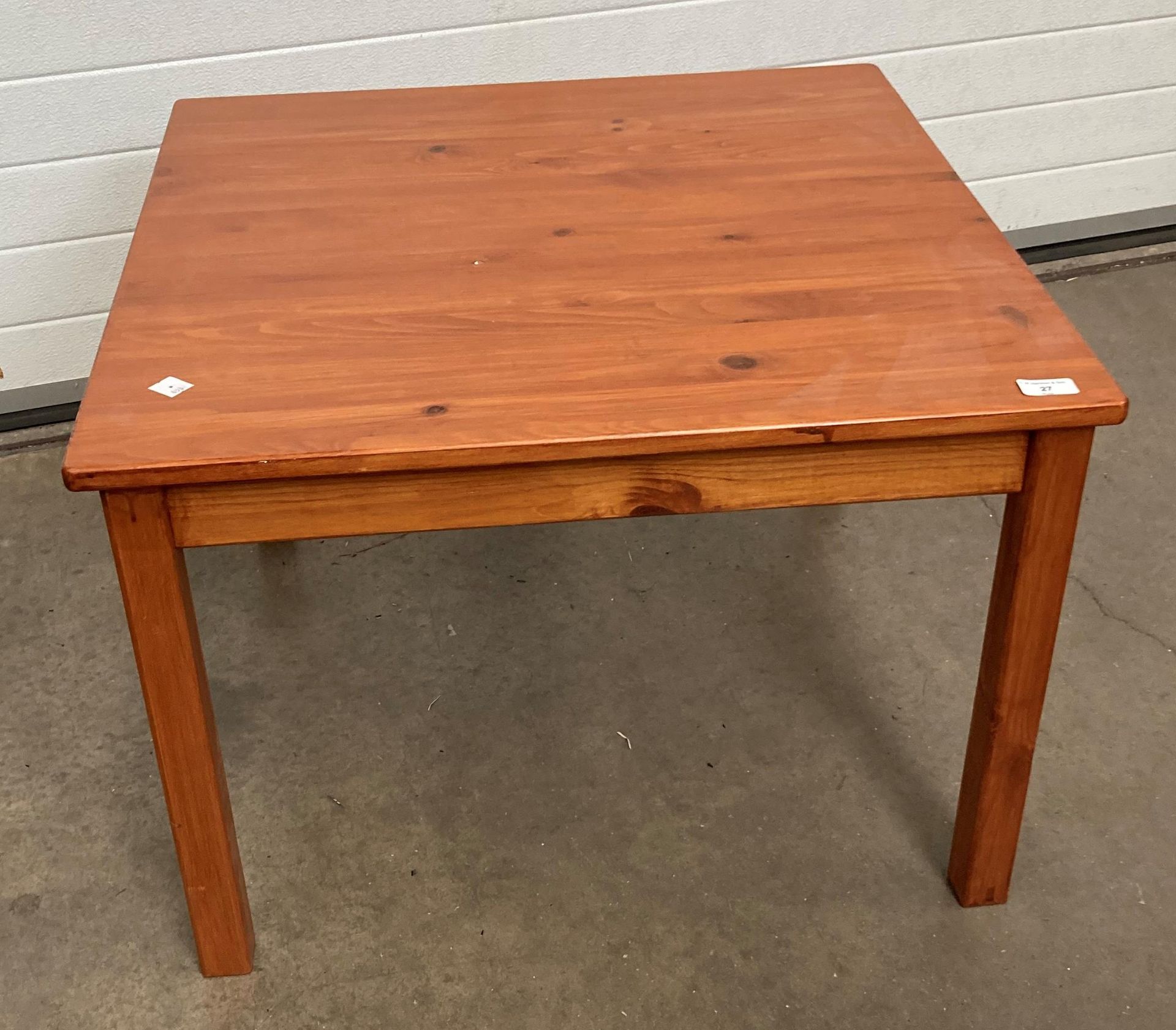 A stained pine square coffee table 70cm x 70cm x 50cm high