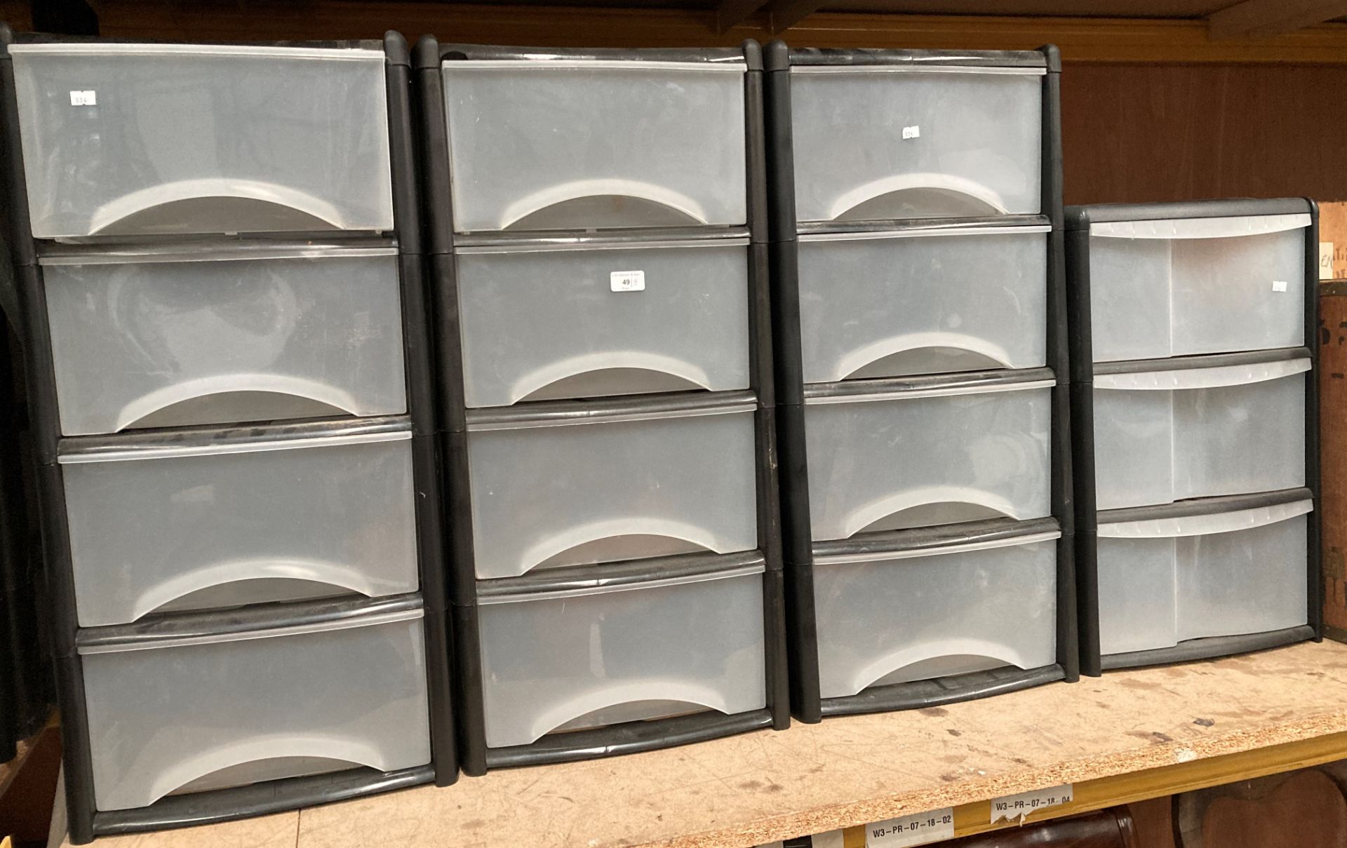 Eight 3 and 4 drawer black plastic storage units