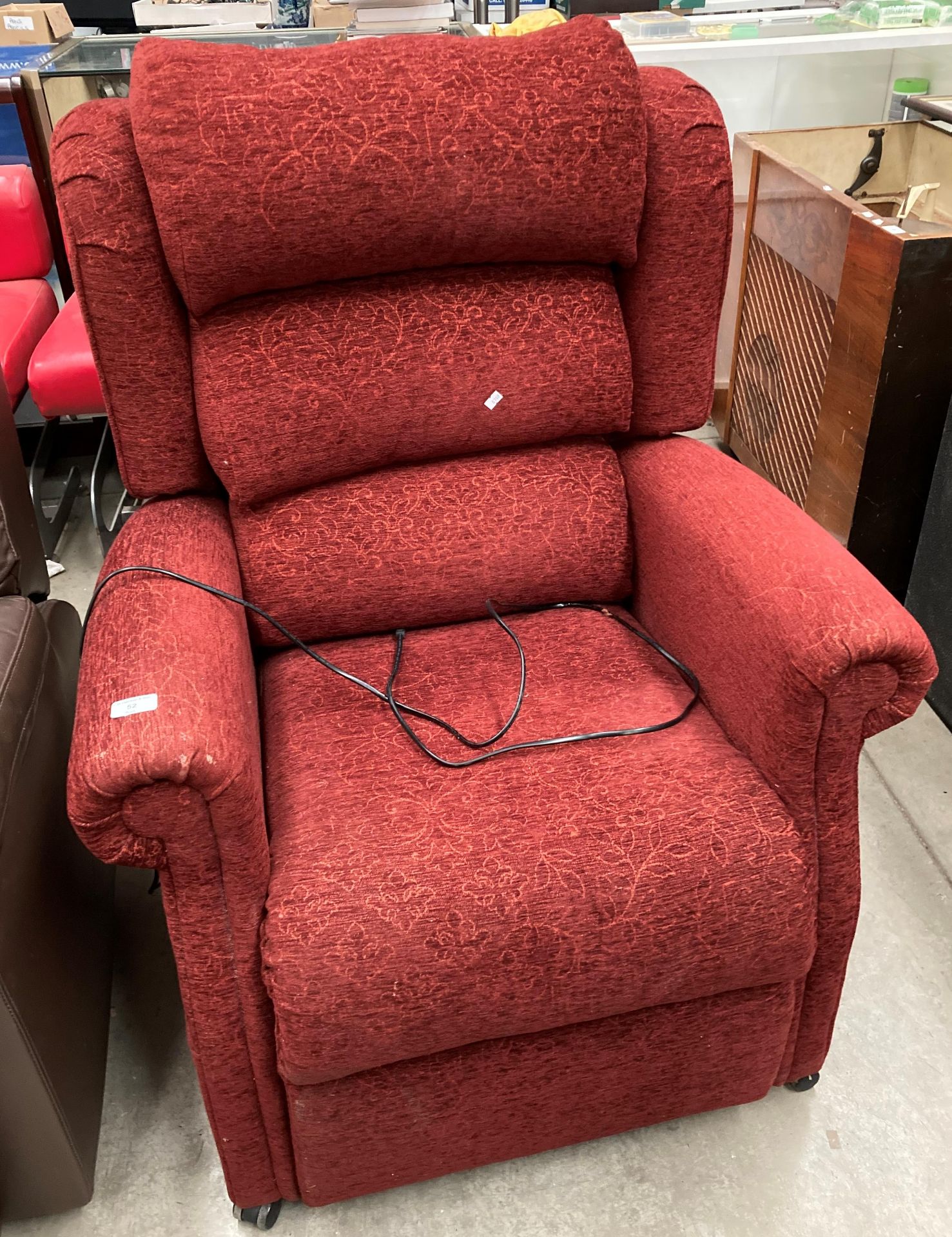 A red cloth upholstered electric reclining armchair Further Information It is a