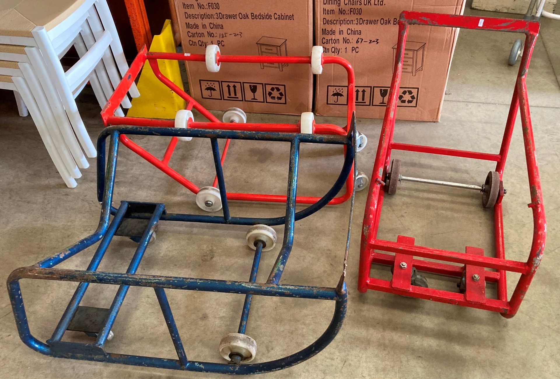 Two red metal and one blue metal barrel trollies (in saleroom)