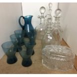 Twelve glass items including three decanters, lidded wine jug,