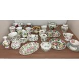 Twenty-nine pieces on coffee coloured tablecloth including seventeen pieces of Queen's china mainly