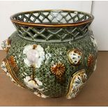 Jardiniere with lattice rim and embossed floral design in green, brown, pink and white,