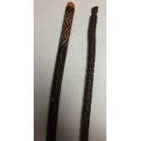 A walking stick 102cm long and pole 150cm long both carved with patterns and the pole with the head