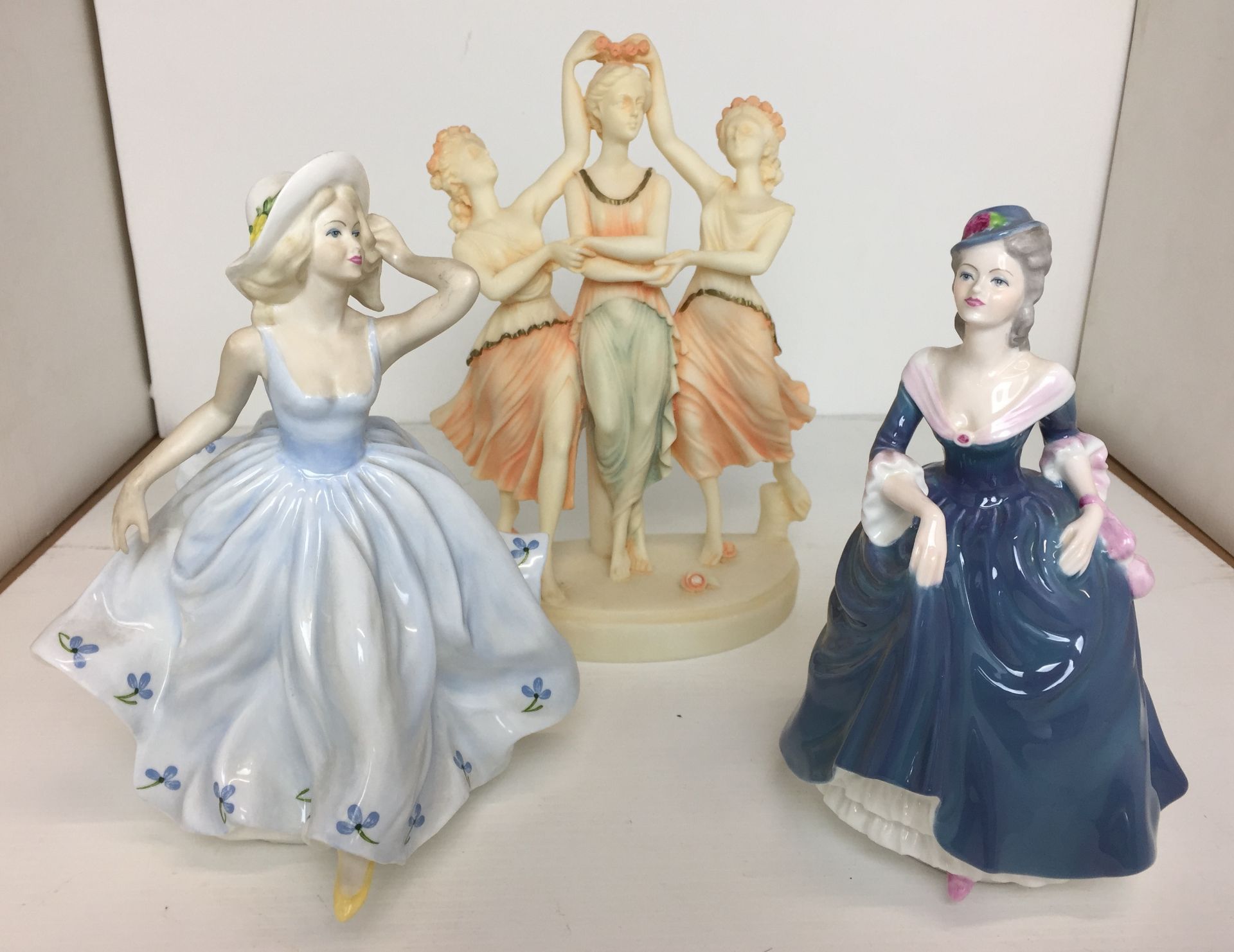 Three figurines - two Coalport china ladies of fashion Debbie and Regina,