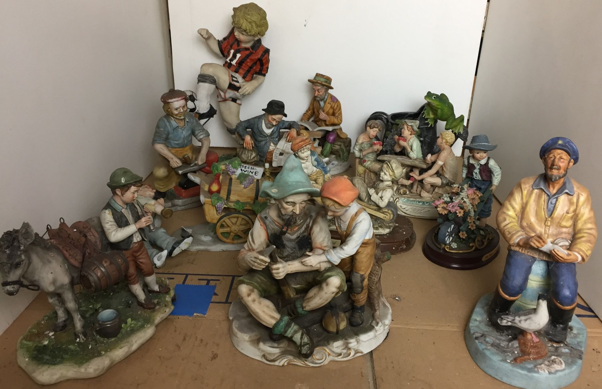 Twelve porcelain and composite figurines including Royal Doulton The Seafarer 23cm high,