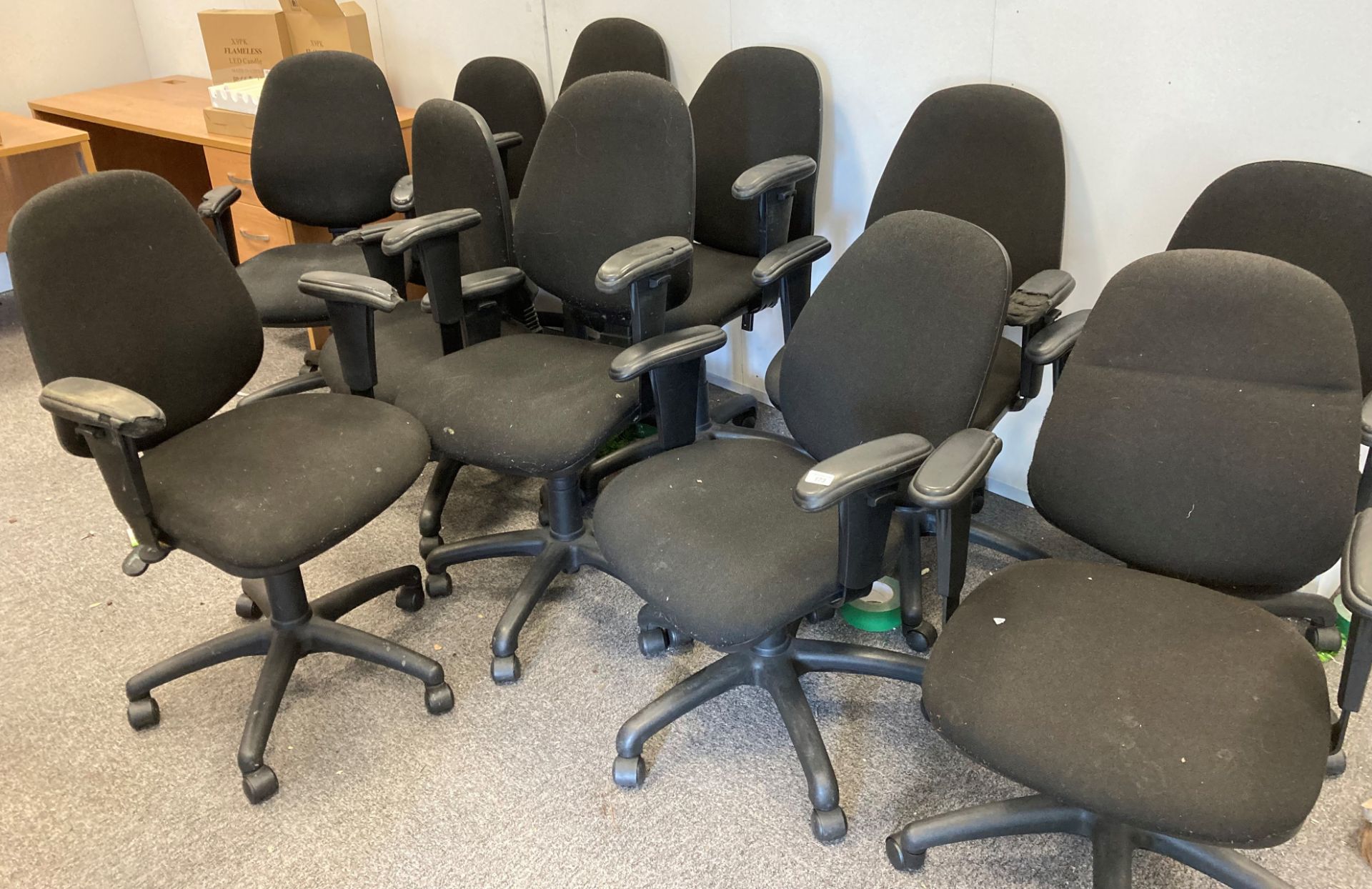 11 x black cloth upholstered operators swivel armchairs.