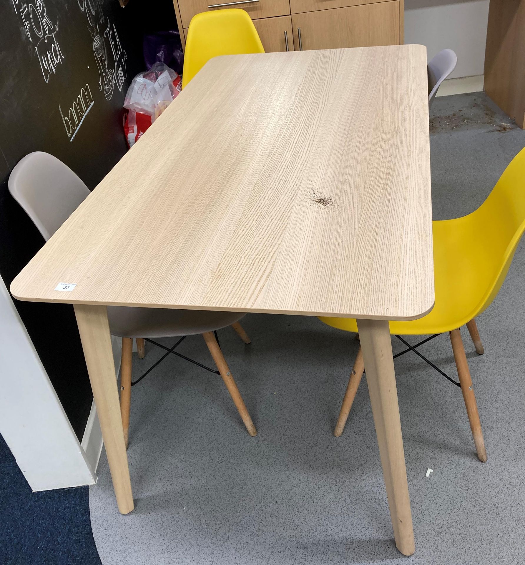 Melamine topped kitchen table 140cm x 80cm and 4 x plastic stacking chairs on wooden legs.