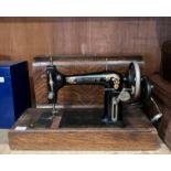 A New Home Sewing Machine Company USA New Home 'D' manual sewing machine in portable oak finish