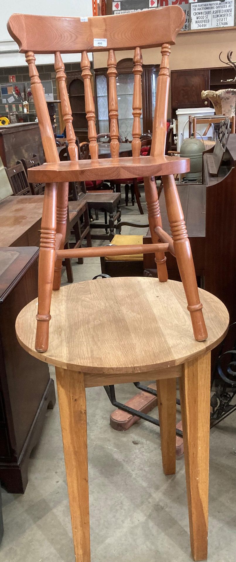 An oak circular table 61cm diameter and an oak wooden dining chair.