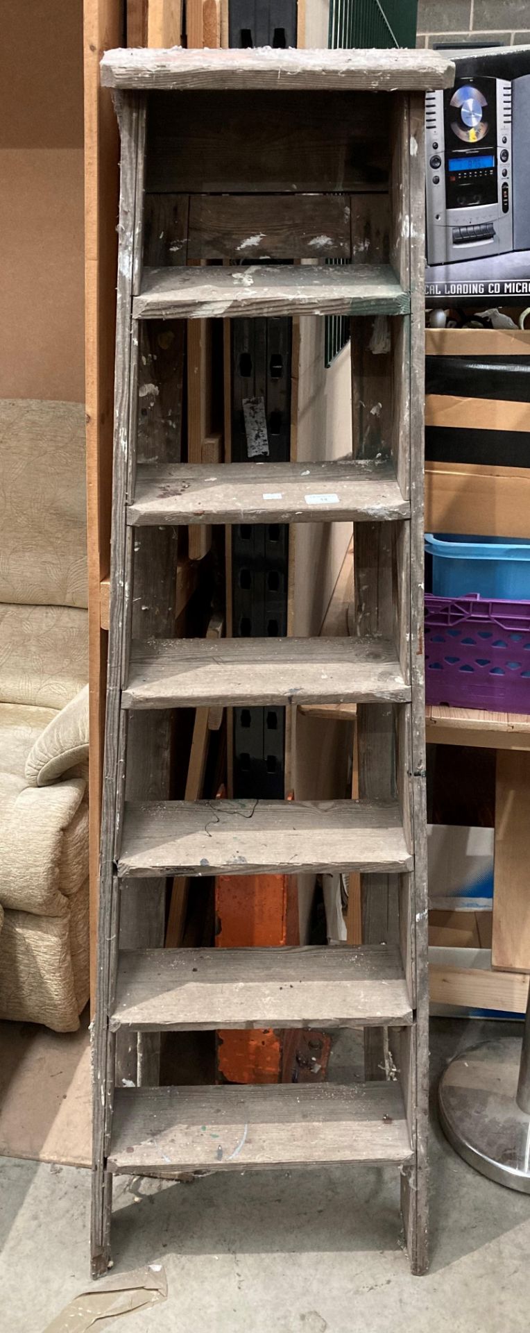 A wood six step stepladder.