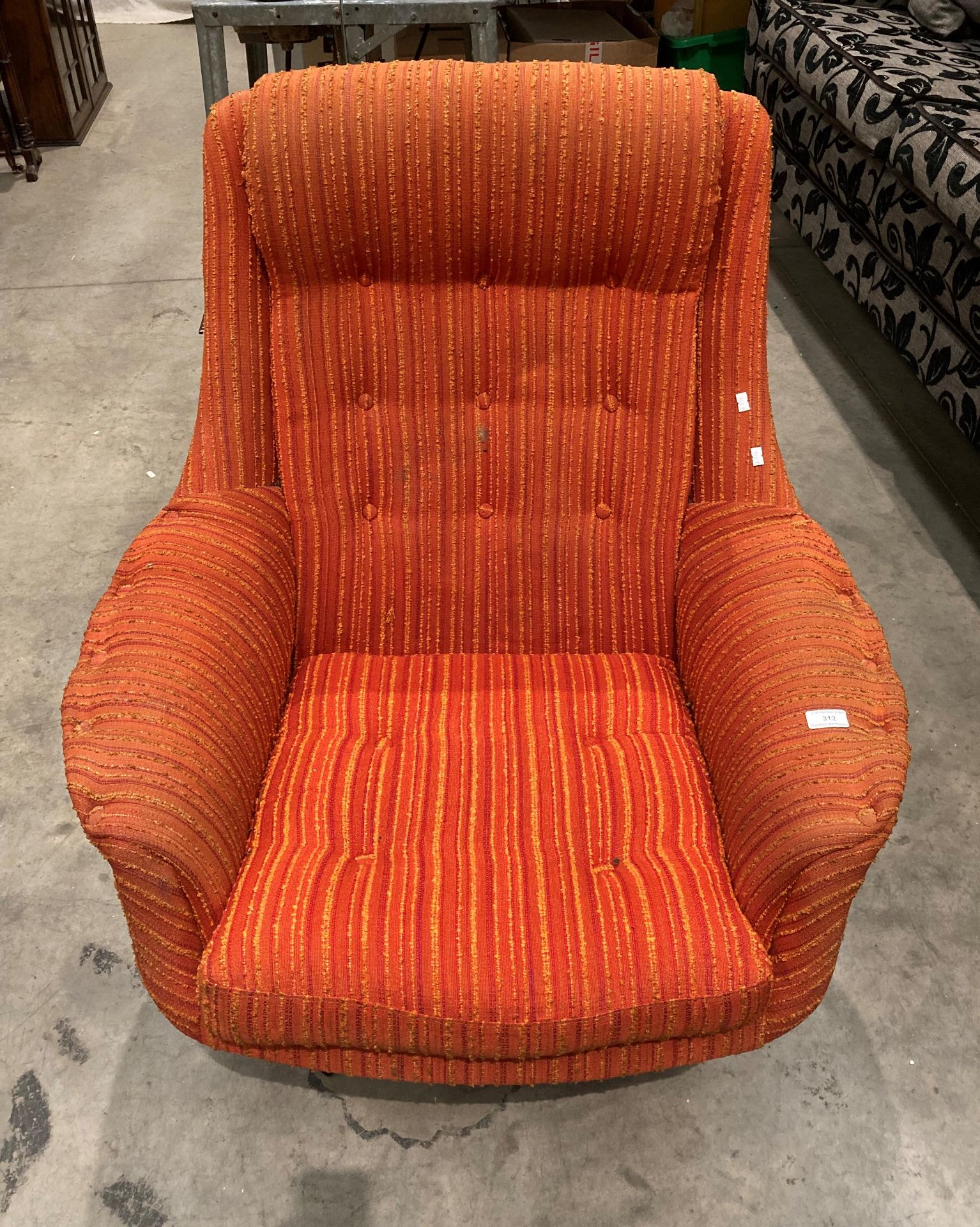 A retro orange pattern upholstered swivel armchair (Sold as a work of art - not for use in a