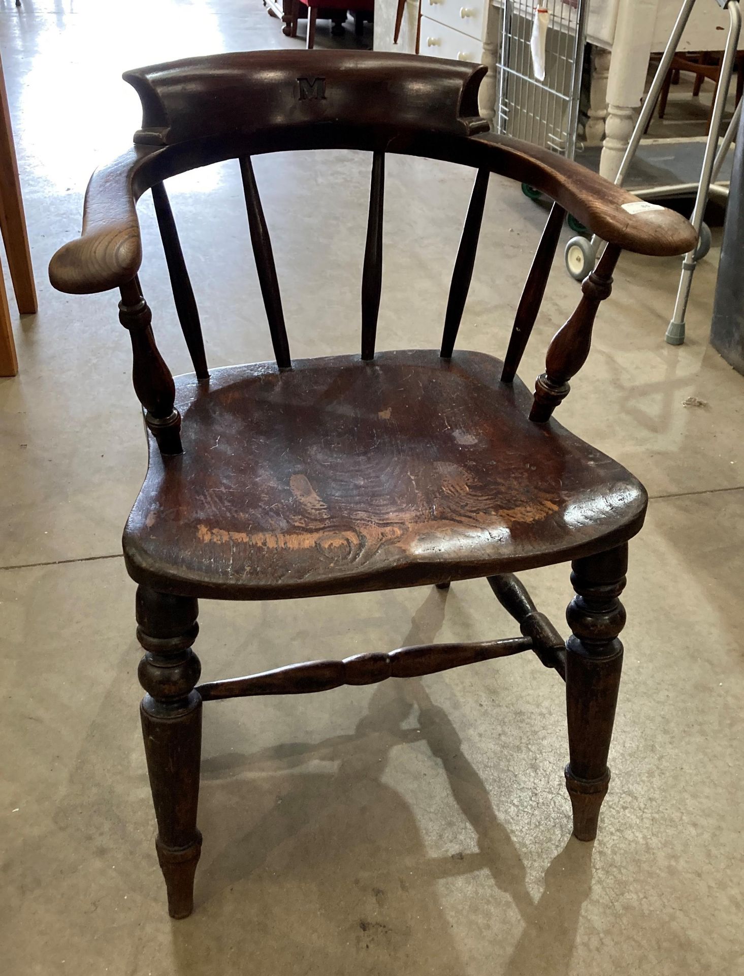 An elm smoker's bow armchair initialled 'M' to centre back rail (S3O)