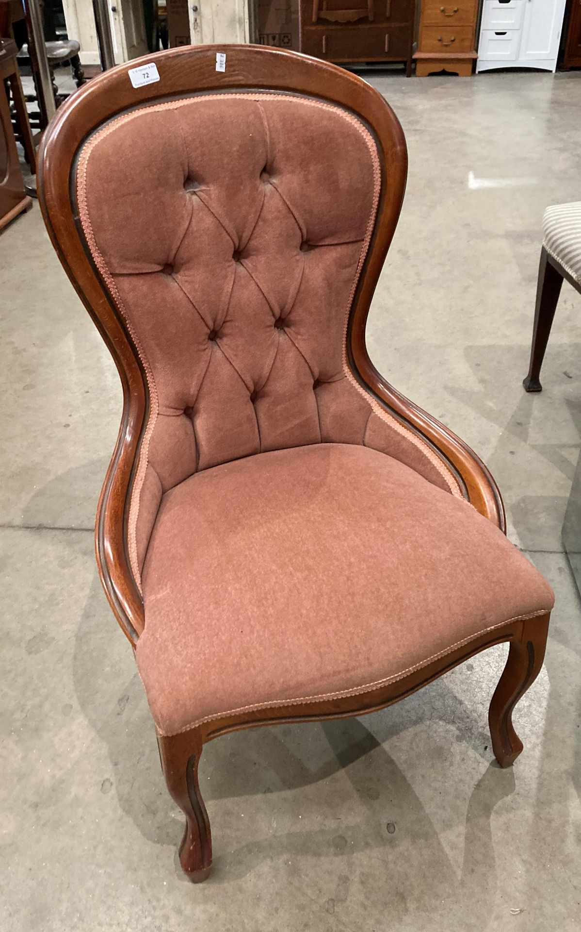 A mahogany nursing chair with pink deep buttoned back dralon upholstery [Please note - the