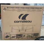 A boxed Cornilleau Sport 100 indoor table tennis table, blue, folds upright for storage,