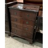 A small mahogany finish serpentine front chest of drawers,