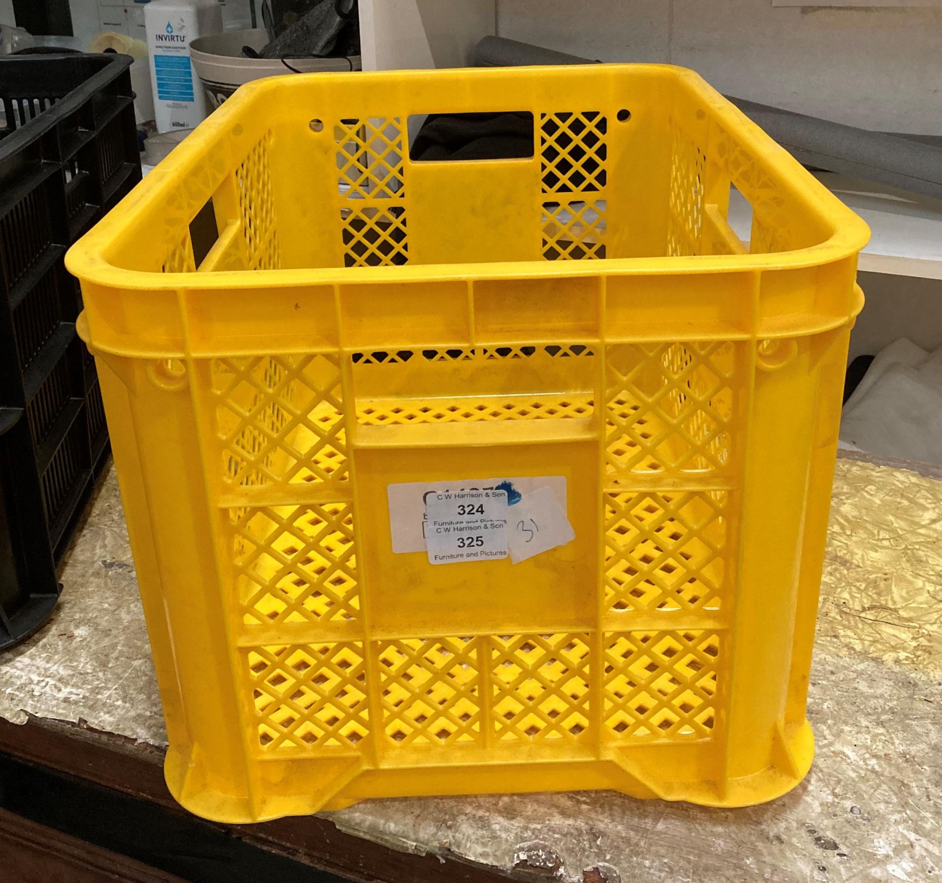 Twenty-four yellow/orange plastic crates,