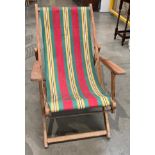 A wood framed deck chair with red,