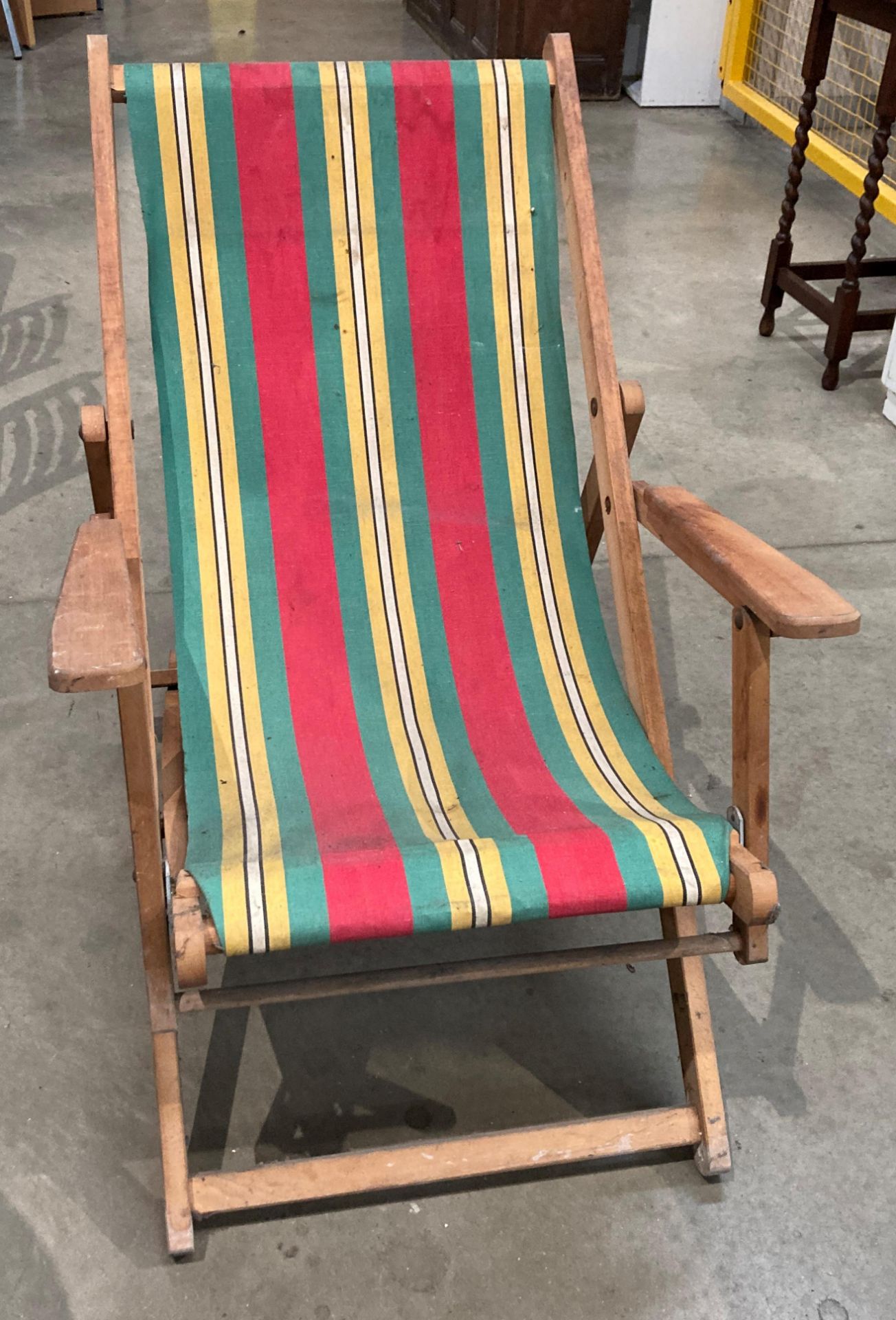 A wood framed deck chair with red,