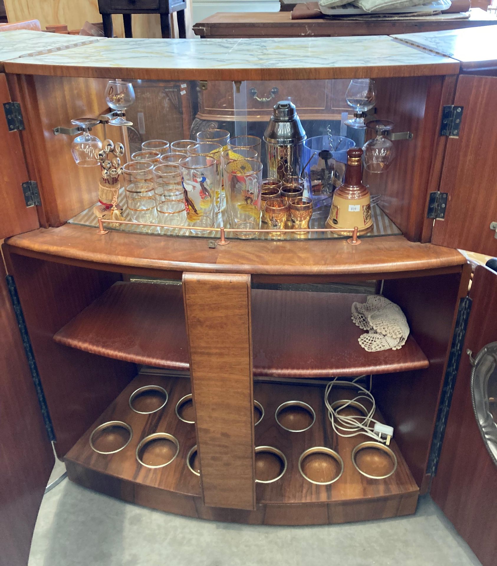 A 1950s walnut finish curved double sided bar with marble effect folding top over two doors and - Image 3 of 7